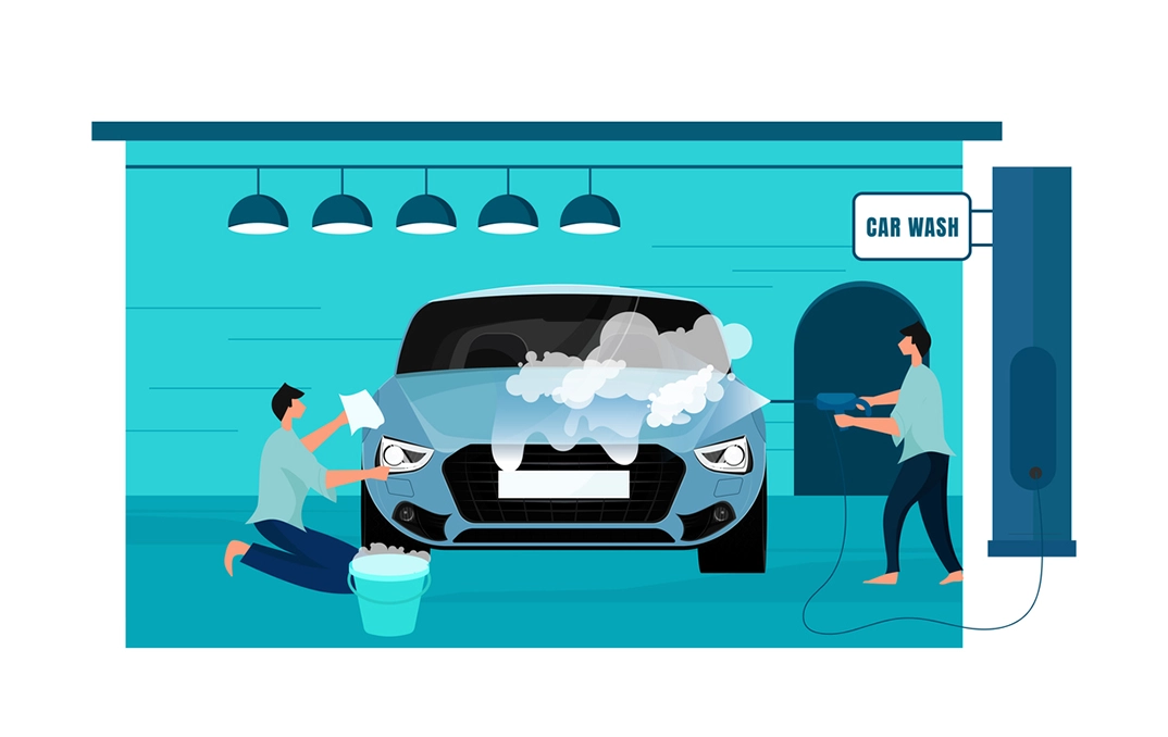 Two men washing a car in the garage.